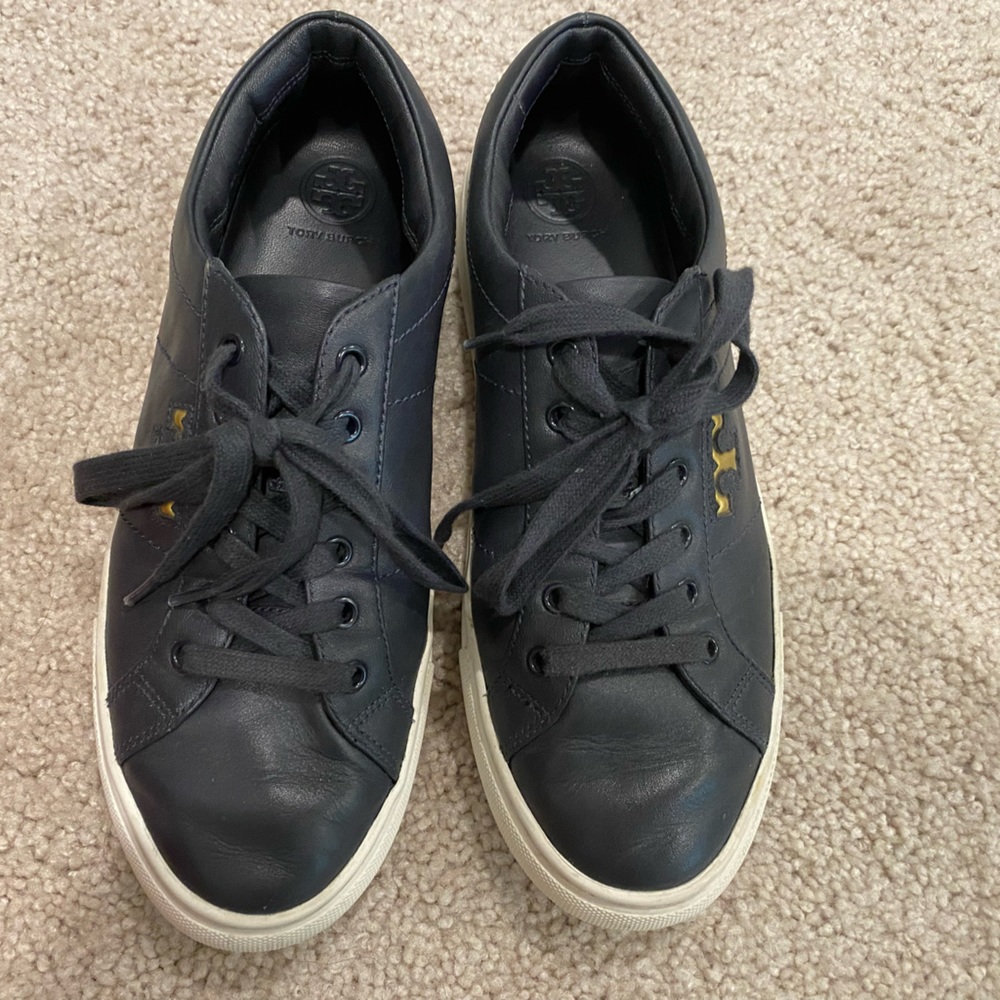 Tory Burch Amalia Sneaker. The color is navy blue with gold T.